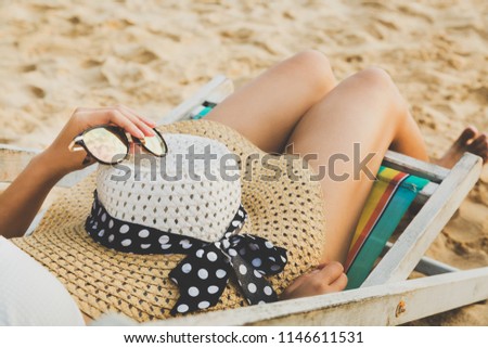 Summer beach vacation concept, Asian woman with hat relaxing and sunglasses on chair beach at Koh Mak, Trad, Thailand