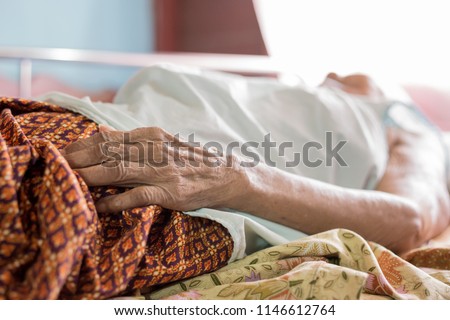 closeup hand of old woman , wrinkle skin, asian palliative patient sleep on bed Royalty-Free Stock Photo #1146612764