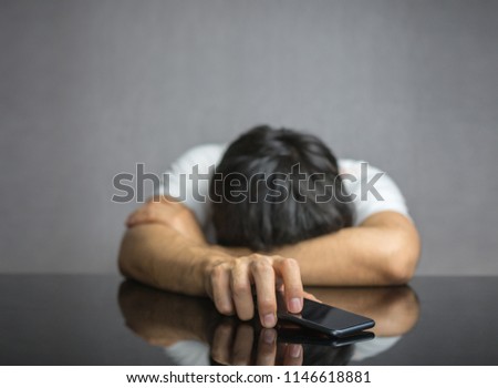 Man waiting for a phone call on table, face down Royalty-Free Stock Photo #1146618881