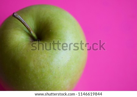 green apple on pink background Royalty-Free Stock Photo #1146619844