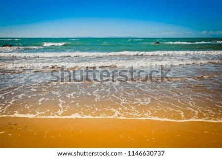 Perfect Beach, Gentle waves caress shore of golden sand. Holiday dreaming. Space for copy.
