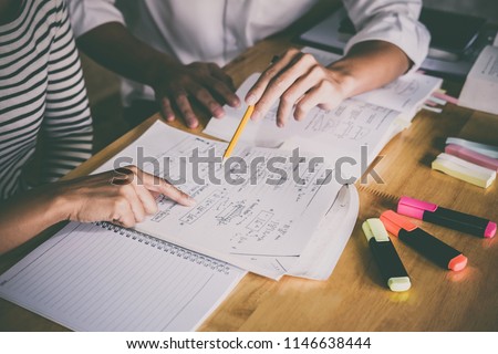 High school or college student group catching up workbook and learning tutoring in classroom and reading, doing homework and lesson practice preparing exam. Royalty-Free Stock Photo #1146638444