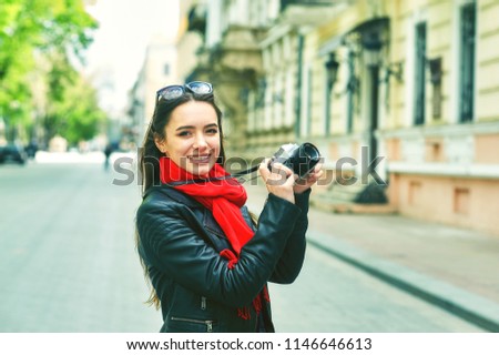 girl photographer in town . girl tourist on the city street