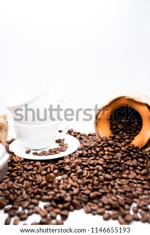 coffee beans and white cup on white background