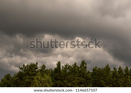 Thunderclouds. dramatic scene. The sun is absorbed by the clouds. The smoke in the sky and the strong wind