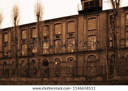 Old industrial derelict building in sepia color