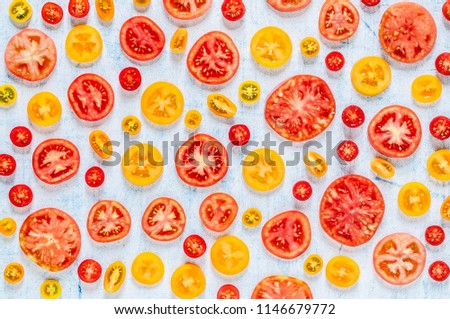 Slices of Various Tomatoes Arranged On the Blue Background