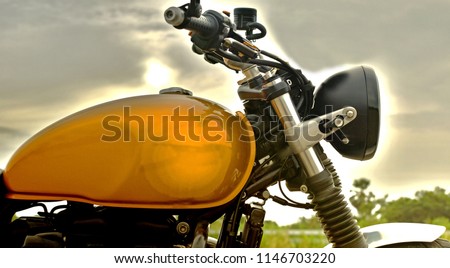 Photography is front part of classic motorcycle standing.  Royalty-Free Stock Photo #1146703220