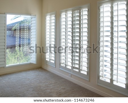 White plantation style wood Shutters for luxury Interior Design in condo. Royalty-Free Stock Photo #114673246