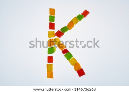 english alphabet of candied fruits on white background