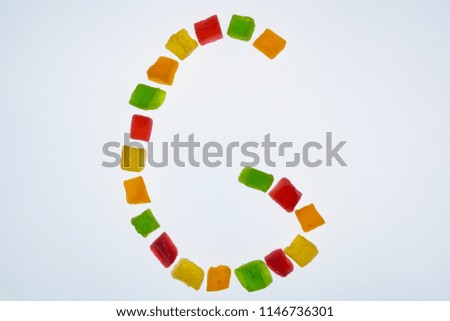 english alphabet of candied fruits on white background