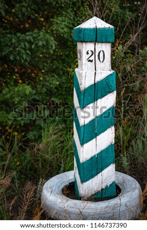 wooden column with stripes, territory designation