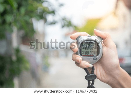 Close Up Of Hand Holding Digital chronometer
