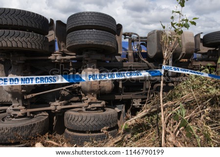 Overturned Lorry on a Quiet Country Lane with "Police Do Not Cross" Tape in Rural Devon, England, UK
