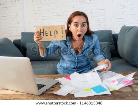 Portrait of worried desperate mother woman feeling stressed while working through finances with laptop and calculator in living room in paying off debts and domestic bills and financial problems