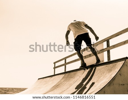 the guy skates on a ramp. tricks.