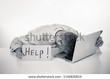 Young attractive caucasian businessmen showing help sign desperate suffering stress at work while sitting at office laptop computer desk in business overwork male feeling stressed and overwhelmed.
