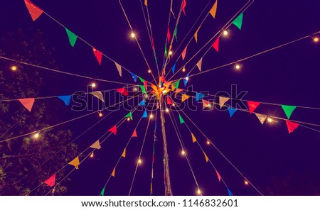 Image of Festival Colorful Flags with Light in Night Time . (vintage tone)