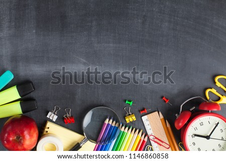 School supplies on black board background. Back to school concept Royalty-Free Stock Photo #1146860858