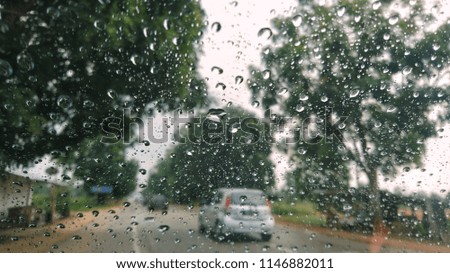 Rain water on the glass car. View through the car window.