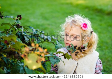 adorable little blond girl in autumn nature