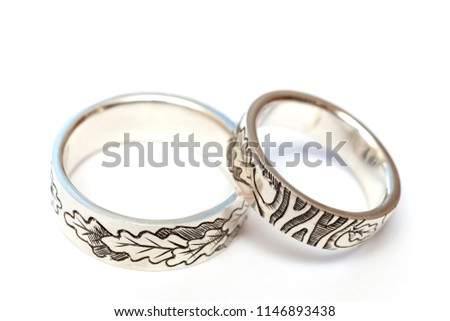 Silver engagement rings with engraving according to the author's sketch. A photo on a white background, isolate.