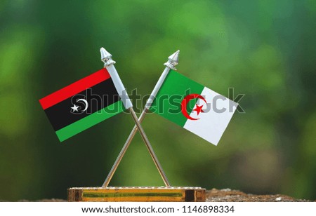 Algeria and Libya small flag with blur green background