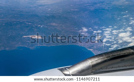 Aerial view of sunny Cyprus Larnaca with blue emerald sea and coastline from aircraft