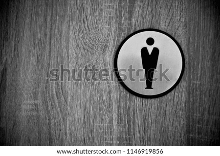 The men's toilet sign on wooden door