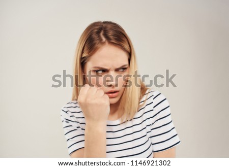     An angry woman is showing a fist.                           