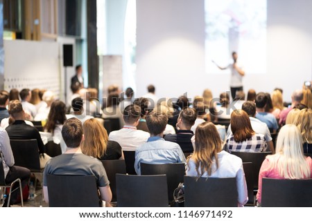 Speaker giving a talk in conference hall at business event. Audience at the conference hall. Business and Entrepreneurship concept. Focus on unrecognizable people in audience. Royalty-Free Stock Photo #1146971492