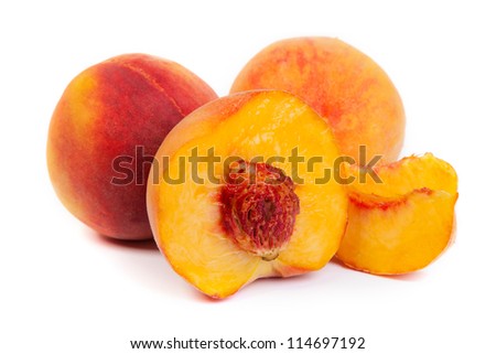Three perfect, ripe peaches isolated on a white background.