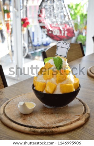 bingsu mango ice cream Korean dessert.Sweet milk serve on wood tray 