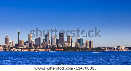 Sydney city CBD cityscape cityline panoramic view from sydney harbour sunny day water and blue sky - major australia landmarks