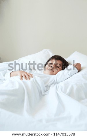 Boy resting in bed, portrait