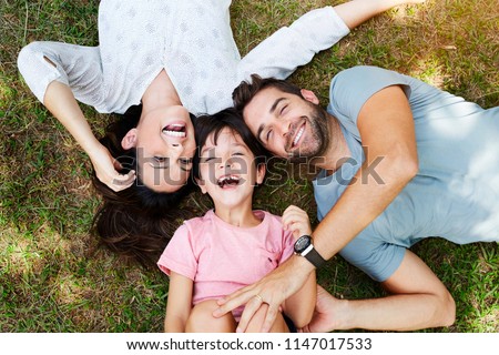 Family smiling together in park