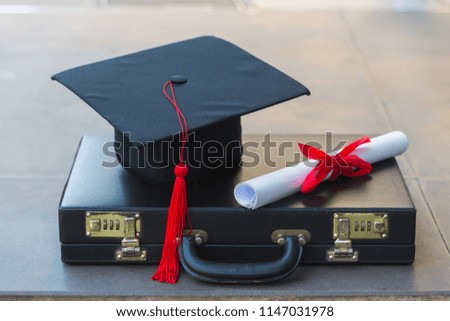 Graduation hat on hard suitcase, Education concept