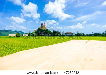 Wat Tham Sua (Sua Cave Temple or Tiger Cave Temple) with rice field and blue sky, Kanchanaburi Province, Thailand