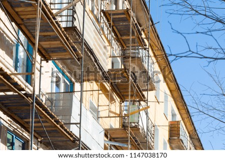 Warming of the apartment house. External repair work on the building, insulation and cladding of the facade of the house