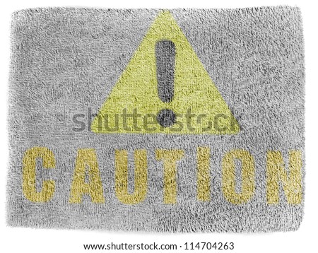 Caution sign painted on grey towel