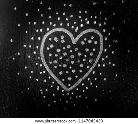 Heart with dots on blackboard.