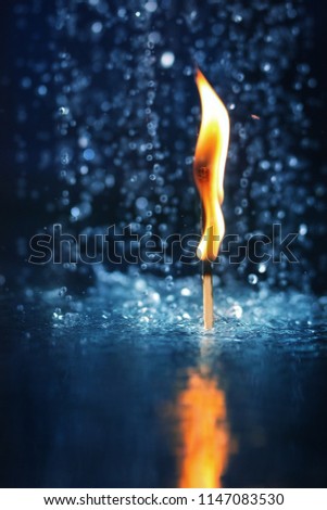 Burning match in the water on a dark blue background conceptual photo Royalty-Free Stock Photo #1147083530