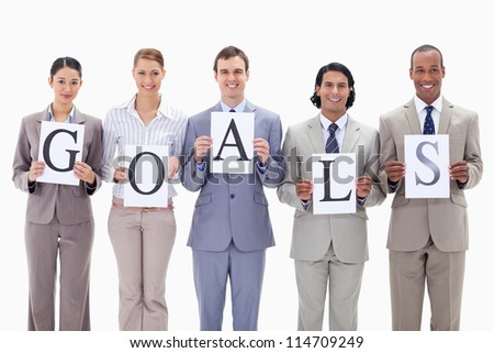 Business team holding the letters of GOALS against white background