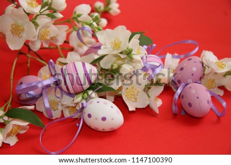 Easter eggs and flowers on a red background.