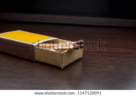 Wooden match on wooden desk background. Selective focus.