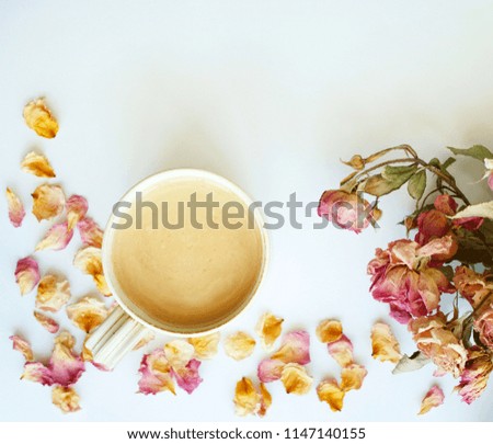 Picture of autumn background with dry roses and cup of coffee with copy space over white background