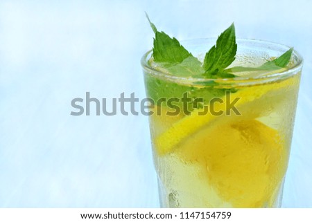 Herbal tea with lemon, cold summer drink with ice, copy space.