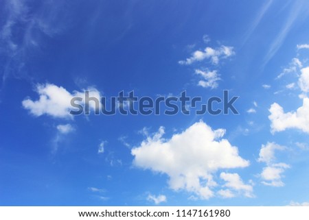 Bright blue sky with scattered clouds.