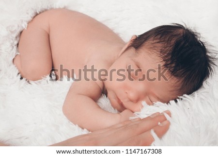 Portrait of newborn baby on a white background.