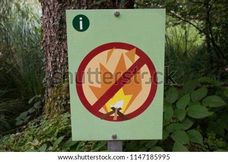 A fire ban sign in the forest.